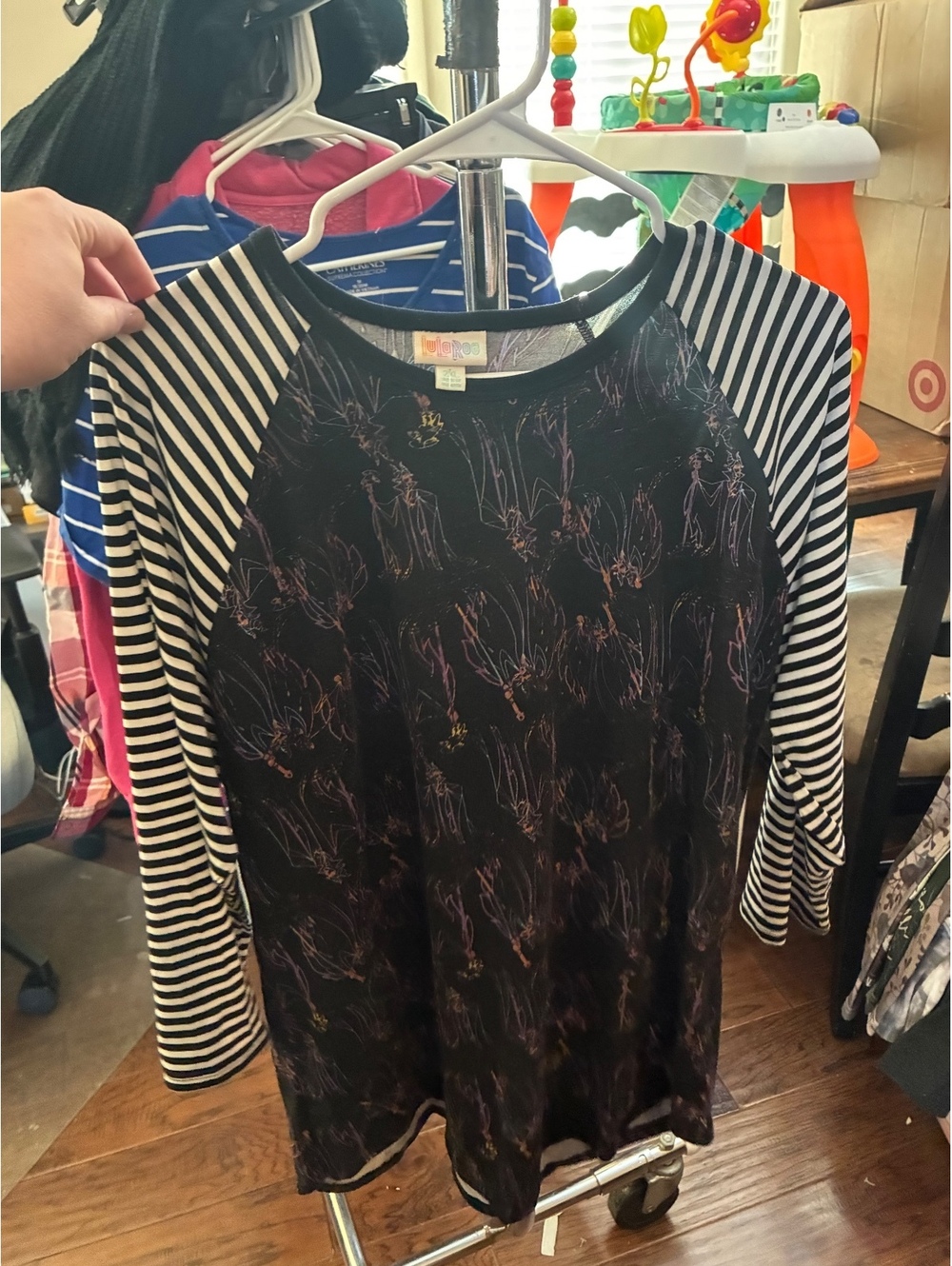 LuLaRoe black floral raglan top with striped sleeves